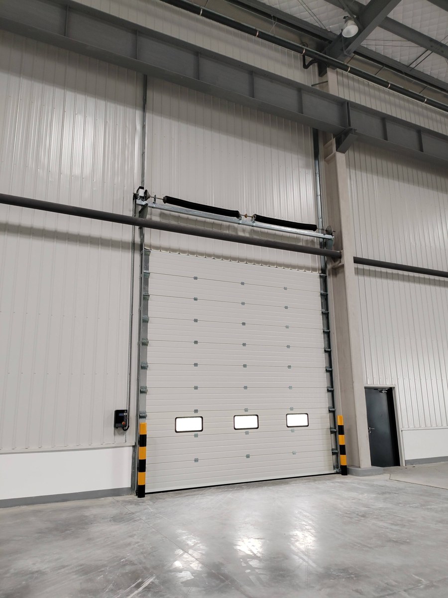 White sectional door with windows and vertical warehouse tracks